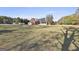 Large backyard featuring a brick house with a screened porch and ample space for outdoor activities at 395 W Mcintosh Rd, Brooks, GA 30205