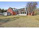 The home's backyard has a large grassy area with a screened-in porch, providing an ideal outdoor living space at 395 W Mcintosh Rd, Brooks, GA 30205