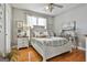 Bright bedroom with hardwood floors, a ceiling fan, and a beautifully decorated bed at 395 W Mcintosh Rd, Brooks, GA 30205