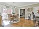 Bright dining area featuring wood floors, French doors, and a round table set for a cozy meal at 395 W Mcintosh Rd, Brooks, GA 30205