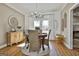 Charming dining area with wood floors, chandelier lighting, and rustic decor that creates a welcoming atmosphere at 395 W Mcintosh Rd, Brooks, GA 30205