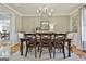 Refined dining room featuring a classic chandelier, neutral decor, and a beautifully set table for elegant dining at 395 W Mcintosh Rd, Brooks, GA 30205