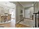 Inviting entryway showcasing neutral colors, a decorative bench, and a view into a dining area with wicker chairs at 395 W Mcintosh Rd, Brooks, GA 30205