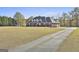 Elegant brick home with a covered porch and manicured lawn at 395 W Mcintosh Rd, Brooks, GA 30205