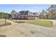 Expansive brick home with attached garages, a well-manicured lawn, and a long driveway at 395 W Mcintosh Rd, Brooks, GA 30205