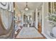 Elegant foyer with hardwood floors, chandelier, and open view to a cozy living space at 395 W Mcintosh Rd, Brooks, GA 30205