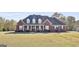 Classic brick home with a covered porch and well-kept front yard at 395 W Mcintosh Rd, Brooks, GA 30205