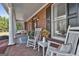 Charming front porch with rocking chairs, brick flooring, and elegant details. Great for relaxation and curb appeal at 395 W Mcintosh Rd, Brooks, GA 30205