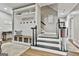 Hallway features a convenient mudroom-style storage unit with bench, baskets, and hooks near the stairs at 395 W Mcintosh Rd, Brooks, GA 30205