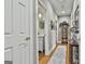 Hallway featuring hardwood floors, access to a bathroom, and elegant decorative touches at 395 W Mcintosh Rd, Brooks, GA 30205