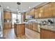 Well-appointed kitchen featuring oak cabinets, granite countertops, and an island with pendant lighting at 395 W Mcintosh Rd, Brooks, GA 30205