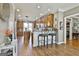 Open concept kitchen with wood floors, stainless steel appliances, and an island with seating for a modern feel at 395 W Mcintosh Rd, Brooks, GA 30205