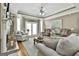 Cozy living room with warm wood floors, comfortable seating, and bright natural light from the French doors at 395 W Mcintosh Rd, Brooks, GA 30205