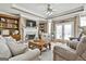 Spacious living room with fireplace, built-in shelving, and plush seating, perfect for relaxation and entertaining at 395 W Mcintosh Rd, Brooks, GA 30205