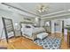 Spacious main bedroom with a large bed, hardwood floors, and stylish furnishings at 395 W Mcintosh Rd, Brooks, GA 30205