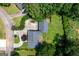 Overhead view of a well-kept home featuring mature trees, lush lawns, and a large driveway at 3778 Berdon Ln, Decatur, GA 30034