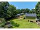 Aerial view of home with expansive lawn, patio, storage shed, and mature trees, offering privacy and space at 3778 Berdon Ln, Decatur, GA 30034