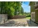 Backyard featuring a sports court with basketball hoop, bordered by privacy fencing and mature trees at 3778 Berdon Ln, Decatur, GA 30034