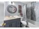 Bathroom with a round decorative mirror, vanity sink, and combined shower and tub at 3778 Berdon Ln, Decatur, GA 30034