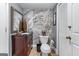 Stylish half bathroom with modern marble accent wall, dark wood vanity, and contemporary fixtures at 3778 Berdon Ln, Decatur, GA 30034