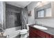 Bathroom with a vanity sink and tub-shower combination featuring stylish tiling at 3778 Berdon Ln, Decatur, GA 30034