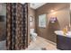 Cozy bathroom features a toilet, sink, vanity, and a shower with stylish curtain at 3778 Berdon Ln, Decatur, GA 30034