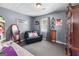 Bedroom with black loveseat, dark-colored carpeting, and a patterned wallpaper at 3778 Berdon Ln, Decatur, GA 30034