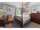 Bedroom with a four-poster bed and decorative accents, including a large dresser and upholstered chair at 3778 Berdon Ln, Decatur, GA 30034