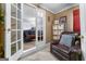 Bedroom with a leather chair and view to another bedroom, with a seating area and bedroom furniture at 3778 Berdon Ln, Decatur, GA 30034
