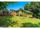 Back exterior features a wooden deck, lush greenery, and a well-maintained lawn, ideal for outdoor enjoyment at 3778 Berdon Ln, Decatur, GA 30034