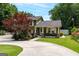 Charming two-story home showcasing lush landscaping, a well-manicured lawn, and a welcoming covered front porch at 3778 Berdon Ln, Decatur, GA 30034