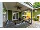 Inviting covered patio with stylish wicker furniture, ceiling fan, grill and a well-manicured backyard at 3778 Berdon Ln, Decatur, GA 30034