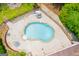 Aerial view of a private backyard pool and outdoor seating surrounded by lush greenery and fencing at 7392 N Mitchell Ct, Villa Rica, GA 30180