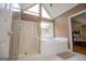 Bathroom features a glass enclosed shower, soaking tub, and natural light at 7392 N Mitchell Ct, Villa Rica, GA 30180