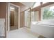 Bathroom features a glass enclosed shower, soaking tub, and walk-in closet at 7392 N Mitchell Ct, Villa Rica, GA 30180
