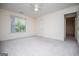 Well-lit bedroom features a window overlooking lush greenery, creating a peaceful and inviting retreat at 7392 N Mitchell Ct, Villa Rica, GA 30180
