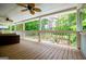 Inviting covered porch with wood flooring, ceiling fans, and a view of the private, lush backyard at 7392 N Mitchell Ct, Villa Rica, GA 30180