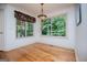 Cozy dining area featuring hardwood floors and bright windows with wooded views at 7392 N Mitchell Ct, Villa Rica, GA 30180