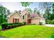 Inviting home with a manicured lawn, red shutters, and a stone accented entrance at 7392 N Mitchell Ct, Villa Rica, GA 30180