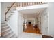 Bright foyer with staircase leading to hardwood living room with fireplace at 7392 N Mitchell Ct, Villa Rica, GA 30180