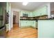 Bright kitchen featuring hardwood floors, stainless steel appliances, and lots of cabinet space at 7392 N Mitchell Ct, Villa Rica, GA 30180