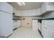 White kitchen area with appliances, ample cabinet space, and vinyl flooring at 7392 N Mitchell Ct, Villa Rica, GA 30180