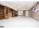 Living area with built-in wooden cabinets and shelving, with an outdoor view at 7392 N Mitchell Ct, Villa Rica, GA 30180