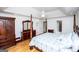 Bright primary bedroom boasts a four-poster bed, wood floors, and custom wood cabinetry at 7392 N Mitchell Ct, Villa Rica, GA 30180