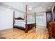 Spacious primary bedroom features a decorative four-poster bed and tray ceiling at 7392 N Mitchell Ct, Villa Rica, GA 30180