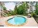 Beautiful in-ground pool with stone surround, lounge seating, and a fenced yard for privacy at 7392 N Mitchell Ct, Villa Rica, GA 30180