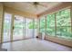Bright sunroom featuring tile flooring, a ceiling fan, and large windows with a view of the outdoors at 7392 N Mitchell Ct, Villa Rica, GA 30180