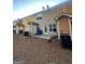 View of townhouse backyards featuring patios, AC units, and varying exterior paint colors at 7050 Galloway Pt, Riverdale, GA 30296