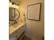Stylish bathroom with a marble countertop, decorative lighting, and a modern round mirror at 7050 Galloway Pt, Riverdale, GA 30296
