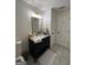 Bathroom features vanity with marble countertop, gold hardware, and sleek gray tile flooring at 7050 Galloway Pt, Riverdale, GA 30296